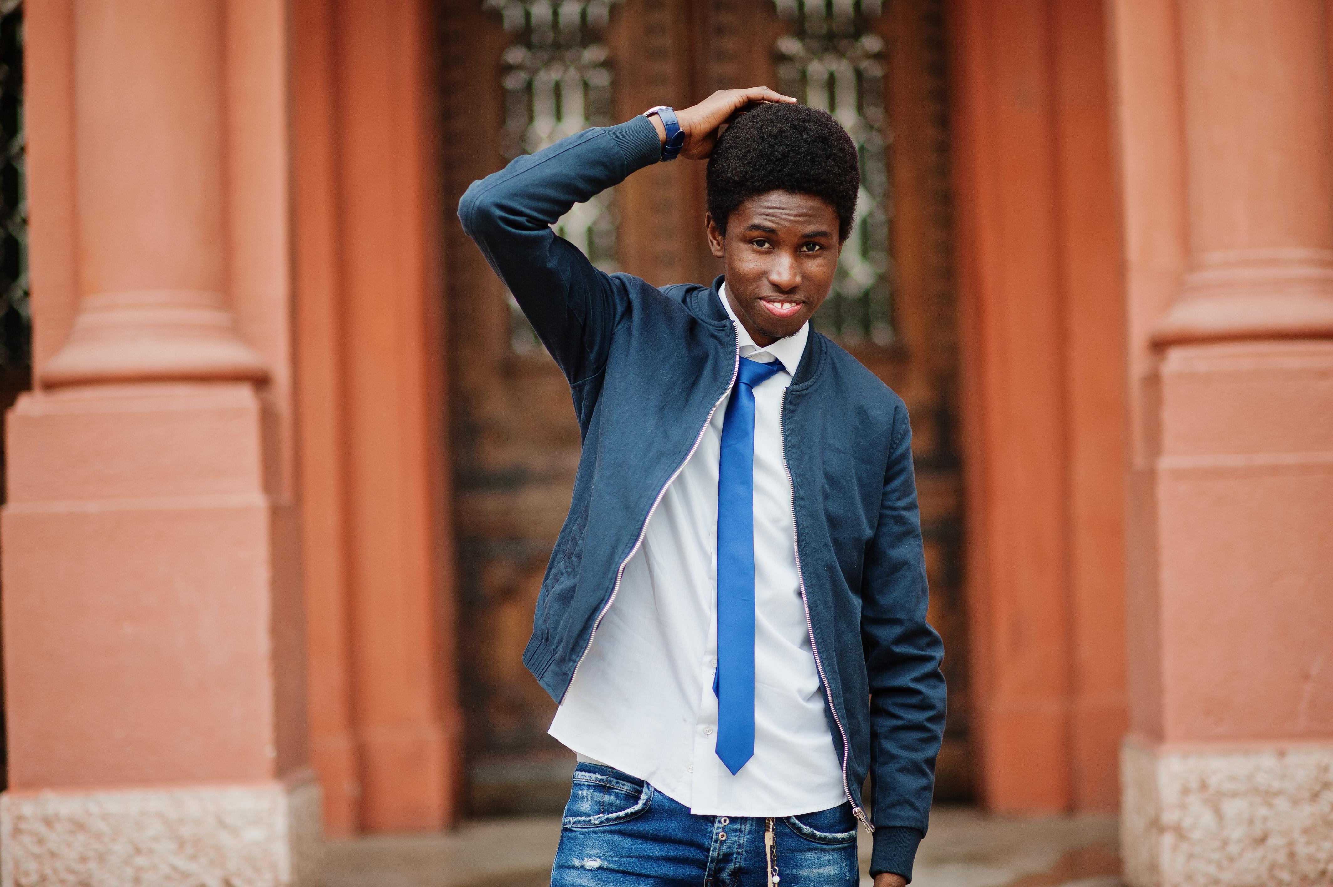 african man wear in tie and casual outfit posing outdoor.